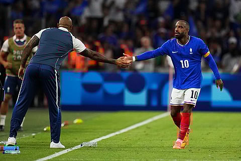 France's Alexandre Lacazette high five's France's head coach Thierry